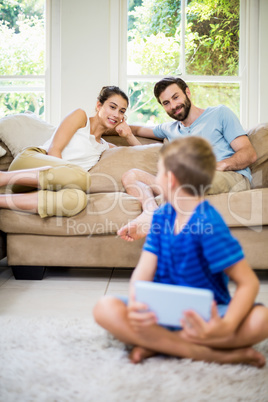 Parents talking to a son while using laptop