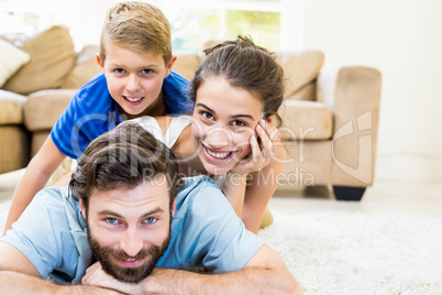 Portrait of parents and son lying on rug