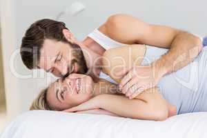 Romantic couple embracing on bed