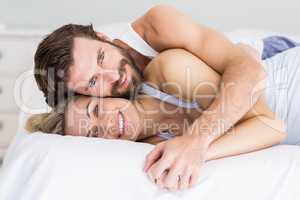 Portrait of romantic couple embracing on bed