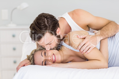 Romantic couple embracing on bed
