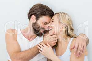 Romantic couple embracing on bed