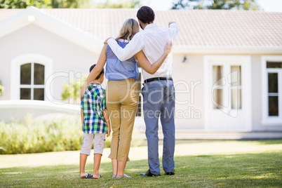 Parents and son standing in garden