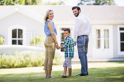 Parents and son standing in garden