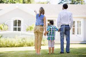 Parents and son standing in garden