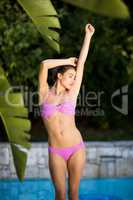 Beautiful woman standing at poolside