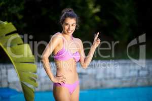 Beautiful woman standing at poolside