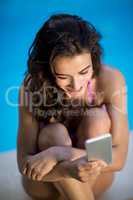 Happy woman text messaging on a mobile phone