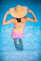 Woman in bikini standing in swimming pool