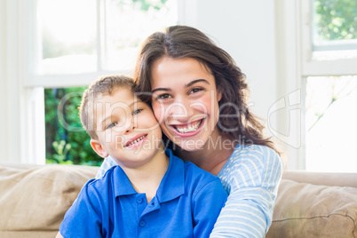 Portrait of mother and son in living room