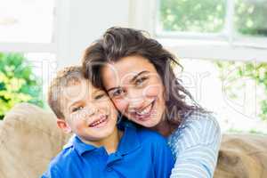 Portrait of mother and son in living room