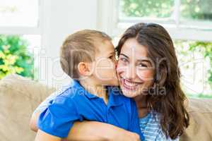 Son kissing his mother in living room