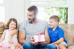 Father receiving a gift from his kids