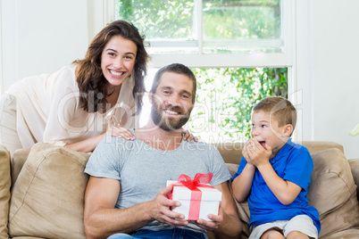 Father receiving a gift from his son and wife