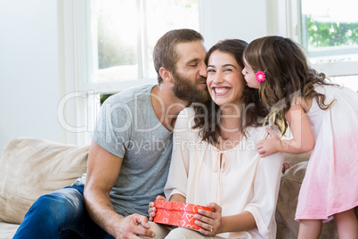 Mother receiving a gift from her husband and daughter