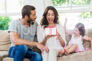 Mother receiving a gift from her husband and daughter