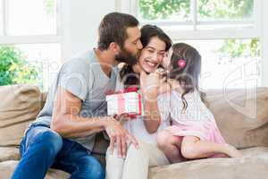 Mother receiving a gift from her husband and daughter