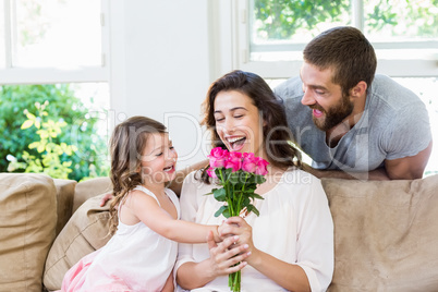 Mother receiving a bunch of flowers from her daughter