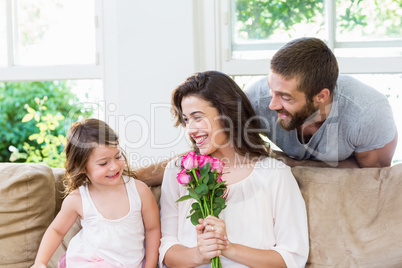 Mother receiving a bunch of flowers from her daughter