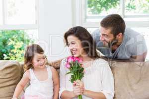 Mother receiving a bunch of flowers from her daughter