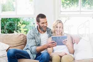 Couple using digital tablet