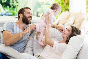 Happy parents playing with their baby