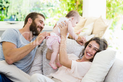 Happy parents playing with their baby