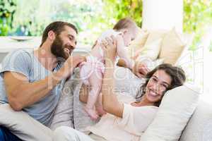 Happy parents playing with their baby