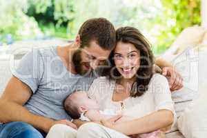 Happy parents with their baby in living room