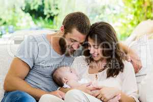 Happy parents with their baby in living room