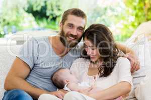 Happy parents with their baby in living room
