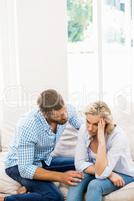 Man comforting her woman in living room