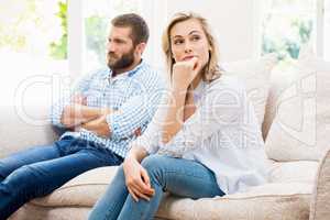 Young couple ignoring each other in living room