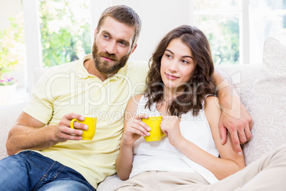 Couple having a coffee in living room