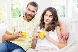 Couple having a coffee in living room