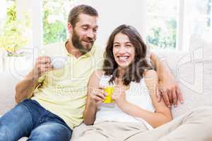 Couple having fun while drinking coffee