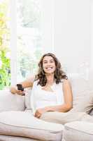 Woman watching television in living room