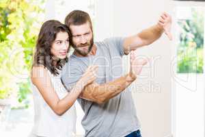 Couple framing a picture with hands