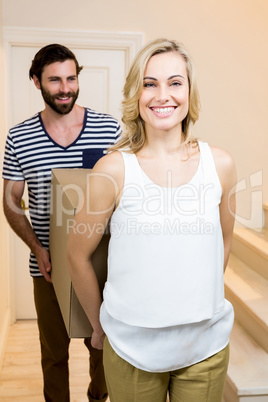 Young couple carrying card board boxes