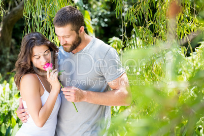 Man offering a rose to woman