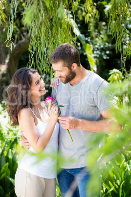 Man offering a rose to woman
