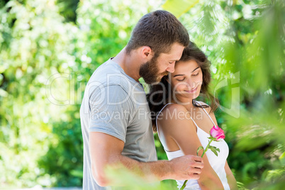 Man offering a rose to woman