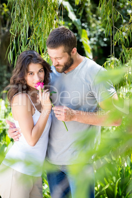 Man offering a rose to woman