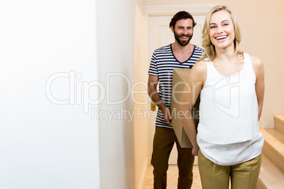 Young couple carrying card board boxes