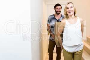 Young couple carrying card board boxes