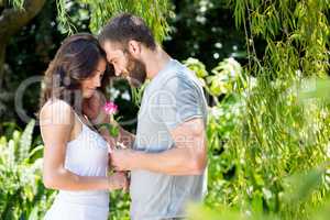 Man offering a rose to woman