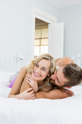 Young couple embracing on bed