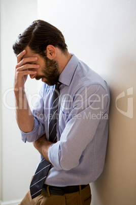 Depressed man with hand on forehead