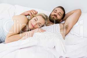 Couple sleeping on bed