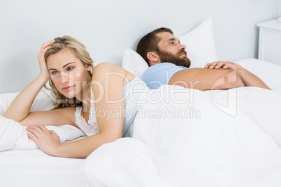 Couple upset after having a fight on bed